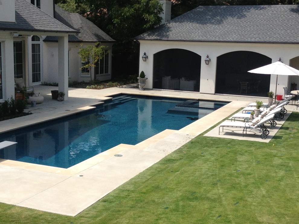 Design ideas for a large contemporary back l-shaped lengths swimming pool in Dallas with a pool house and concrete slabs.