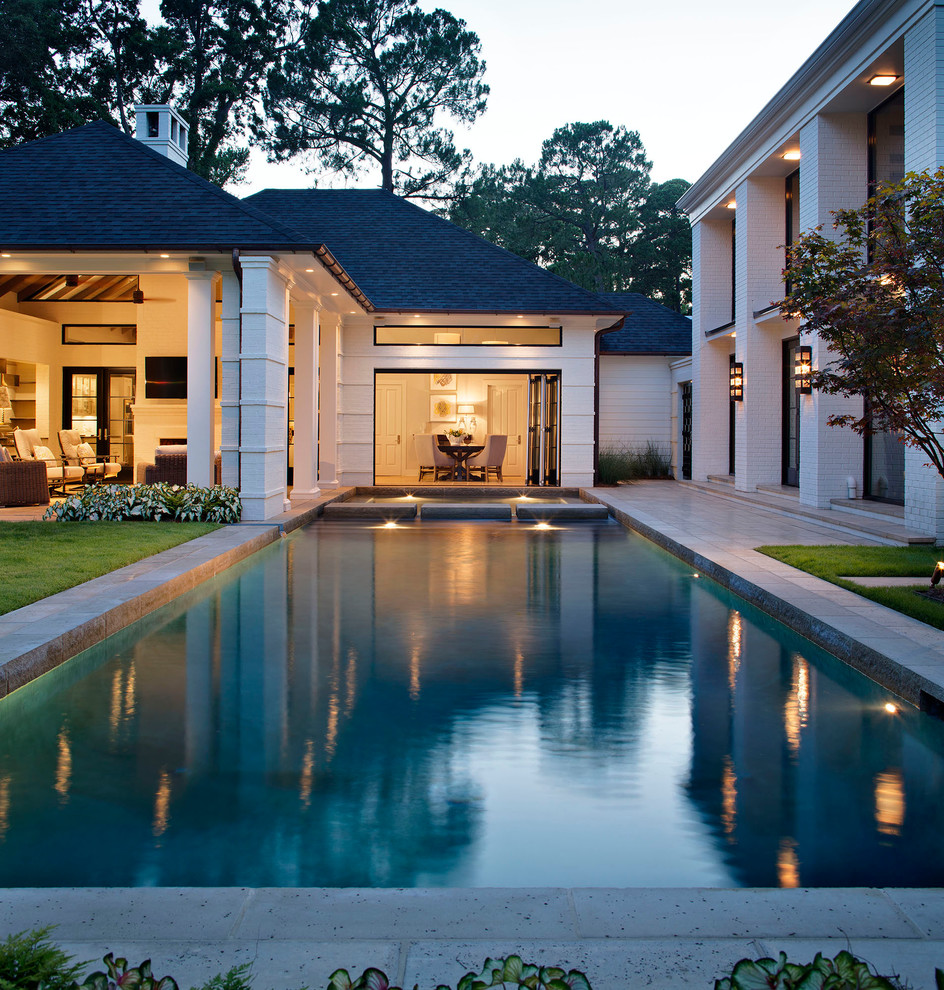 Photo of a large traditional courtyard rectangular swimming pool in San Diego.