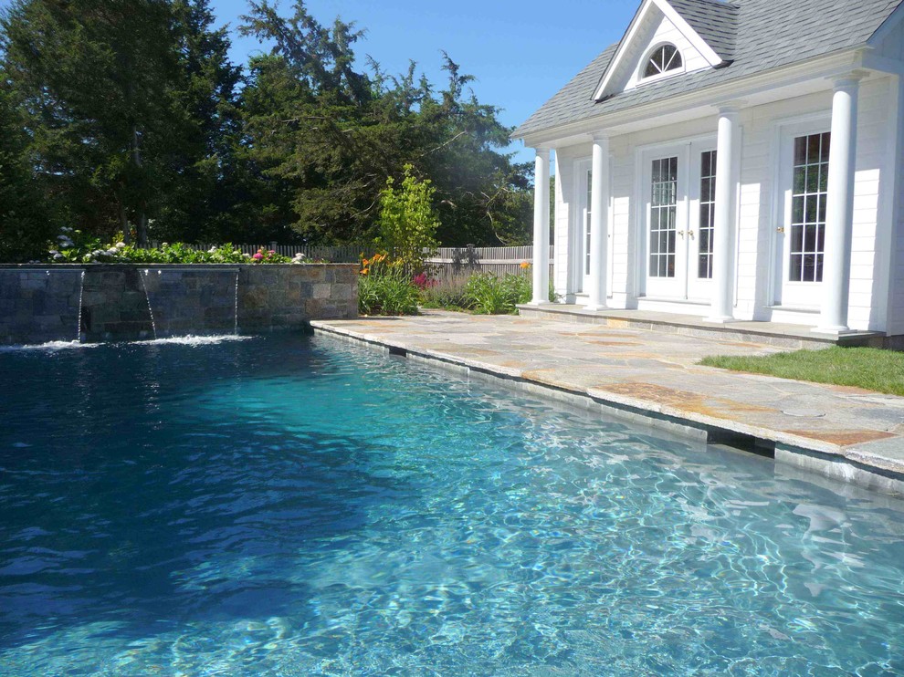 Pool house - traditional backyard stone and rectangular lap pool house idea in Bridgeport