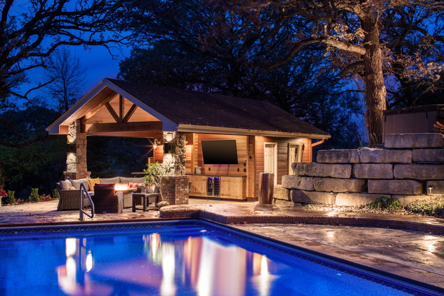 Стильный дизайн: прямоугольный бассейн среднего размера на заднем дворе в стиле кантри с домиком у бассейна и покрытием из каменной брусчатки - последний тренд