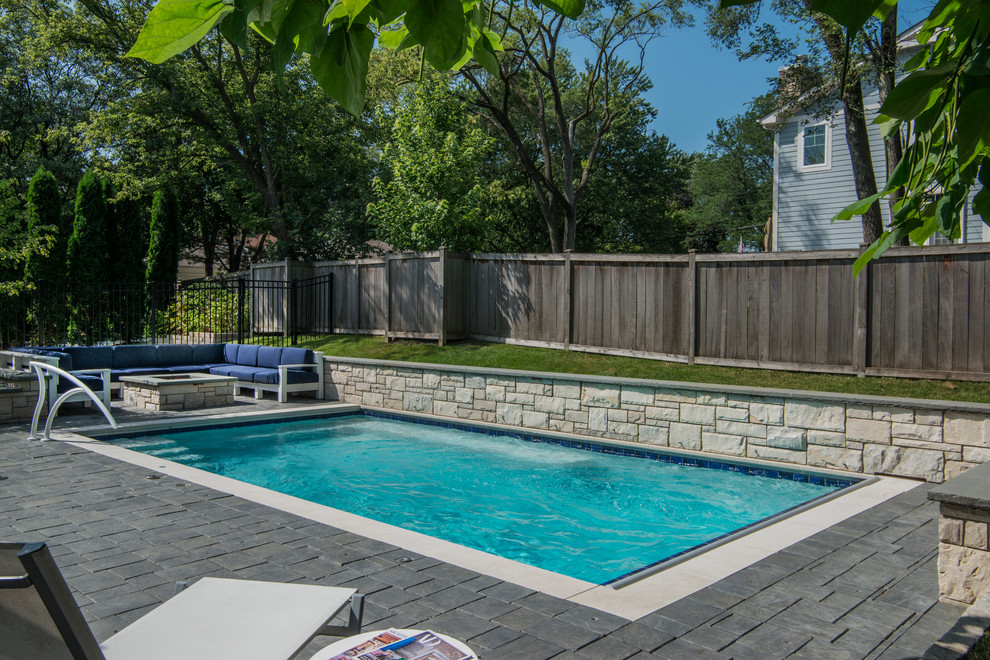 Small classic back rectangular lengths swimming pool in Chicago with concrete paving.