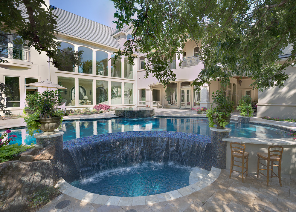 Inspiration for a large eclectic backyard stone and custom-shaped pool remodel in Dallas