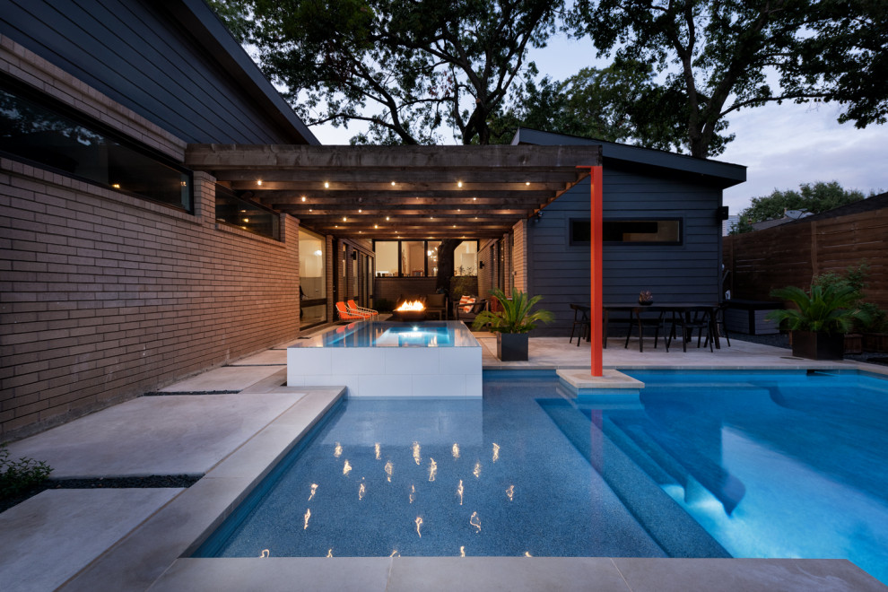 Example of a mid-sized minimalist backyard concrete and l-shaped pool fountain design in Dallas