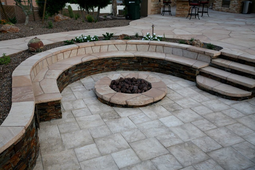 Example of a southwest backyard stone patio design in Phoenix