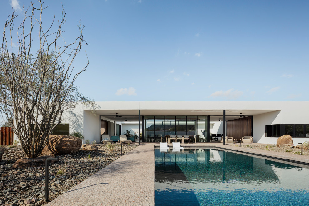 Inspiration for a back rectangular swimming pool in Phoenix with concrete slabs.