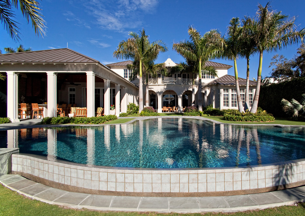 Photo of a large world-inspired back custom shaped swimming pool in Miami.