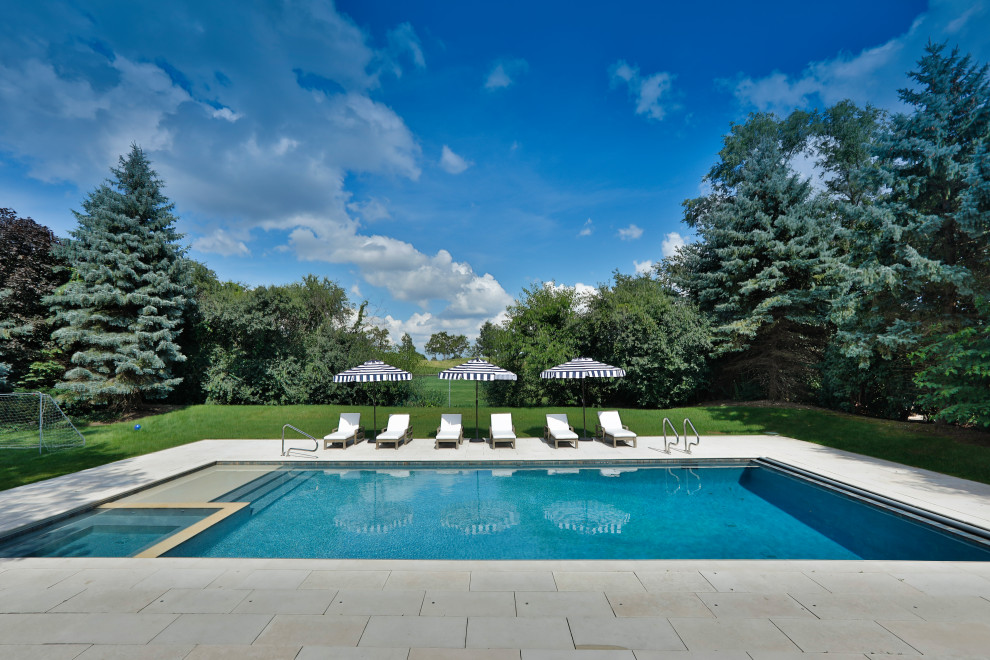 Inspiration for a mid-sized timeless backyard stone and rectangular lap hot tub remodel in Chicago