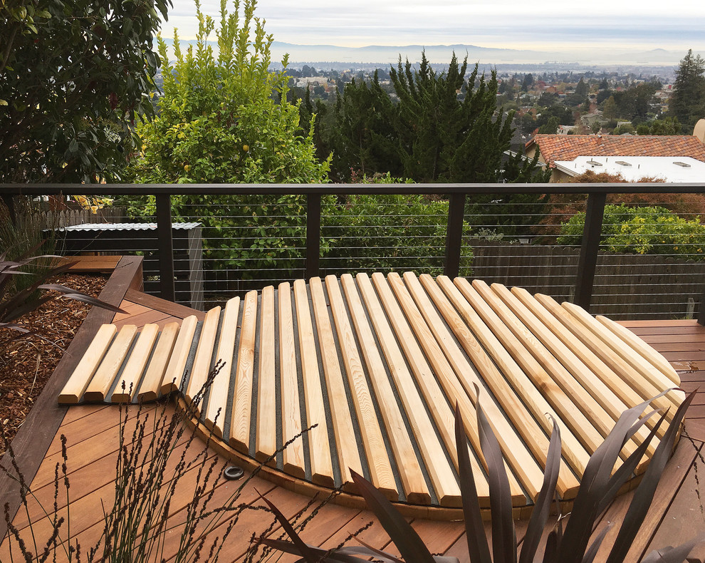 This is an example of a small contemporary back round above ground hot tub in San Francisco with decking.