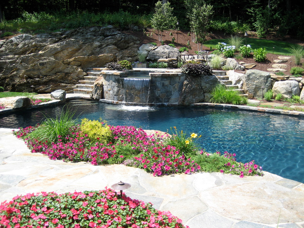 Inspiration for a mid-sized timeless backyard stone and custom-shaped natural pool fountain remodel in New York