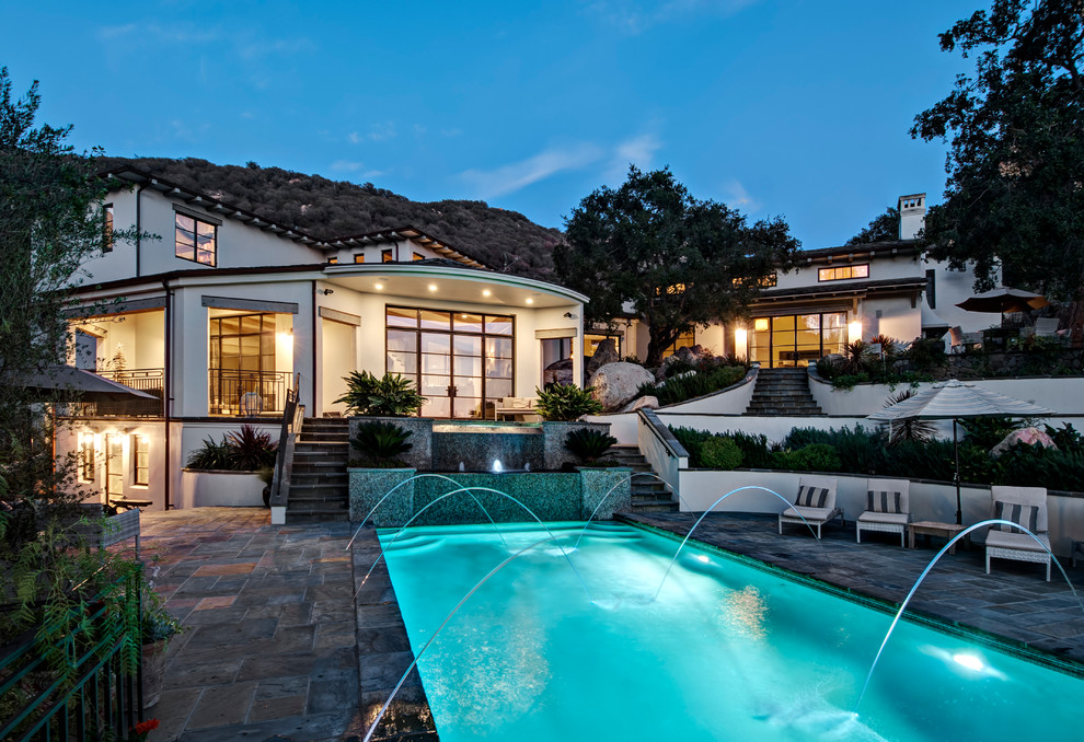 Mediterranean rectangular swimming pool in Santa Barbara with tiled flooring.