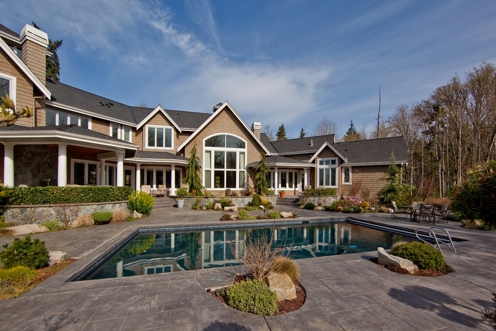Inspiration for a classic back rectangular swimming pool in Seattle with natural stone paving.
