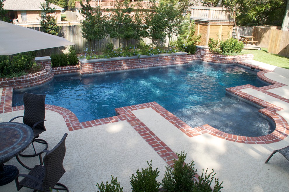 Photo of a medium sized traditional back custom shaped lengths swimming pool in New Orleans with brick paving.