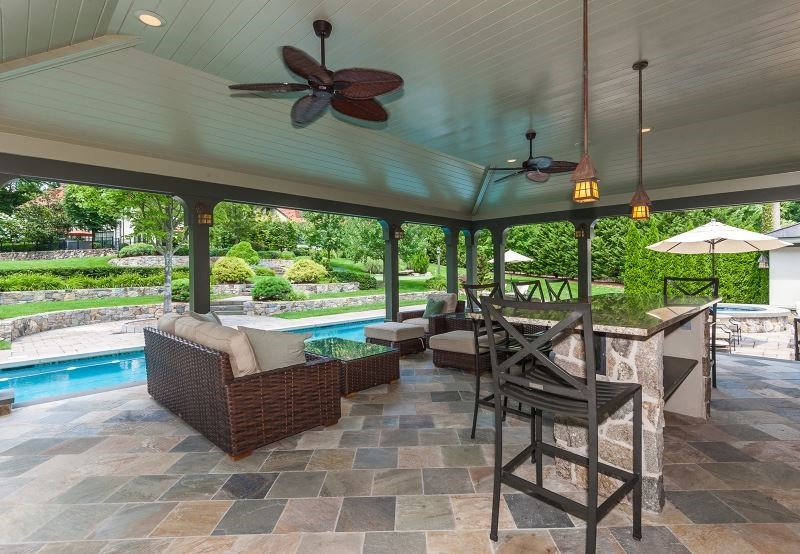 Patio - large traditional backyard tile patio idea in New York
