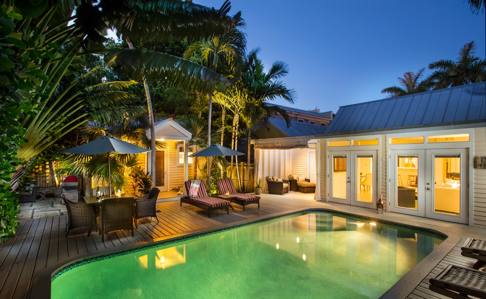 Design ideas for a world-inspired back rectangular swimming pool in Miami with decking.