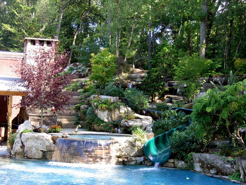 Huge tuscan backyard stone and custom-shaped natural water slide photo in New York