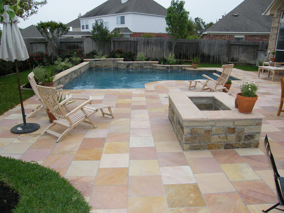 This is an example of a medium sized traditional back custom shaped swimming pool in Houston with a water feature and tiled flooring.