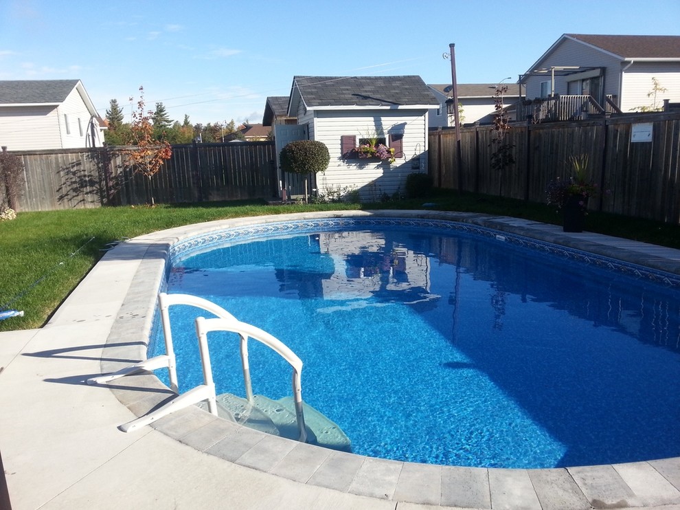 Inspiration for a classic courtyard round swimming pool in Toronto with tiled flooring.