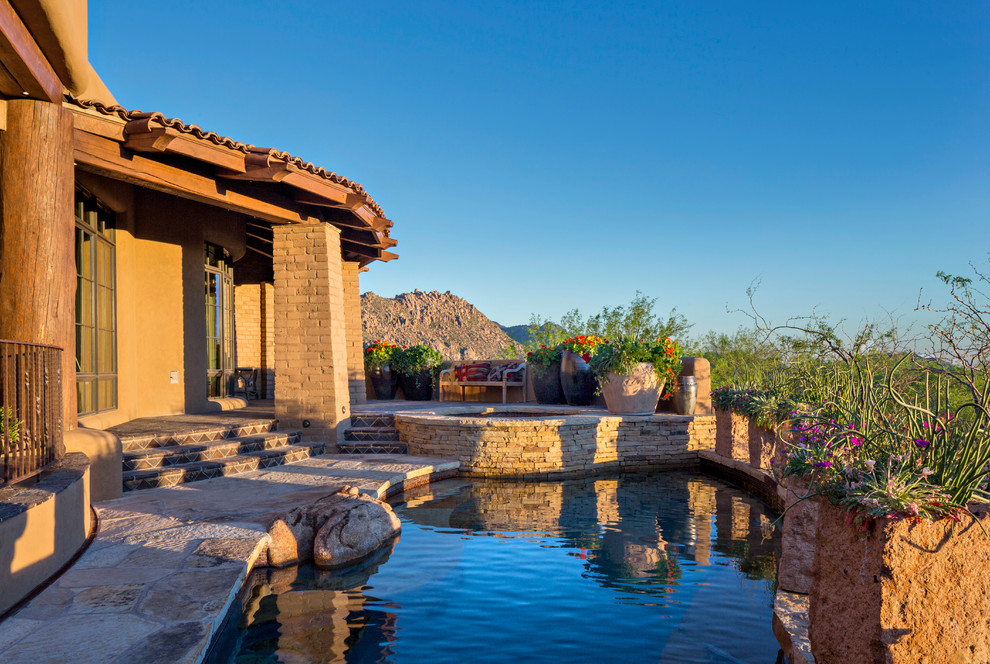 Mid-sized southwest backyard stone pool photo in Phoenix
