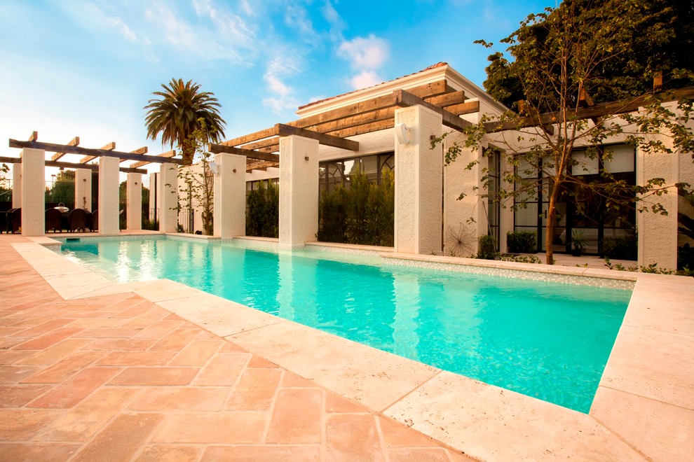 Mediterranean swimming pool in Melbourne with brick paving.