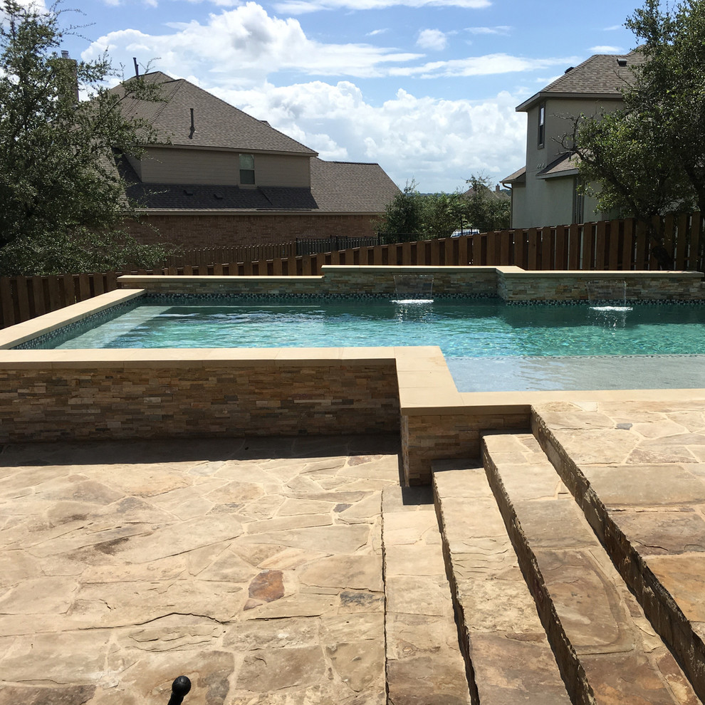 Example of a large classic backyard tile and custom-shaped hot tub design in Austin