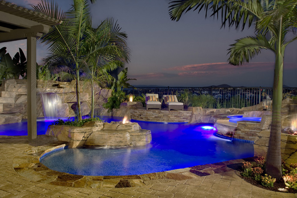 Large tuscan backyard custom-shaped pool photo in Orange County