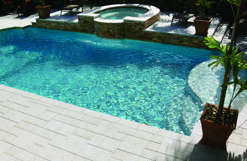 Inspiration for a medium sized back custom shaped natural hot tub in Miami with tiled flooring.