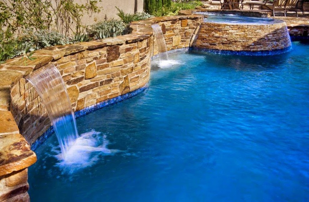 Hot tub - mid-sized transitional backyard stone and custom-shaped natural hot tub idea in Los Angeles
