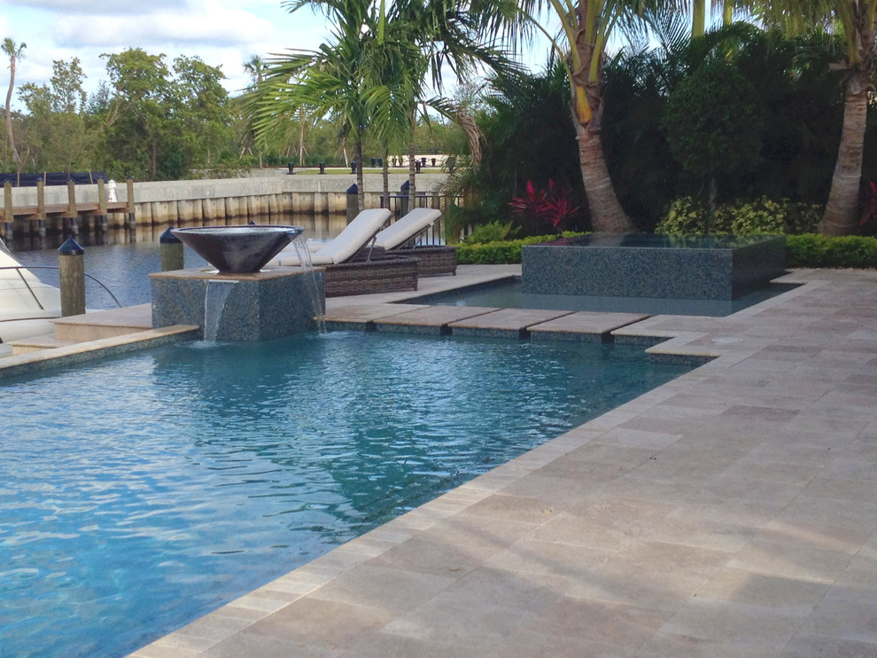 Large trendy backyard rectangular lap pool fountain photo in Miami