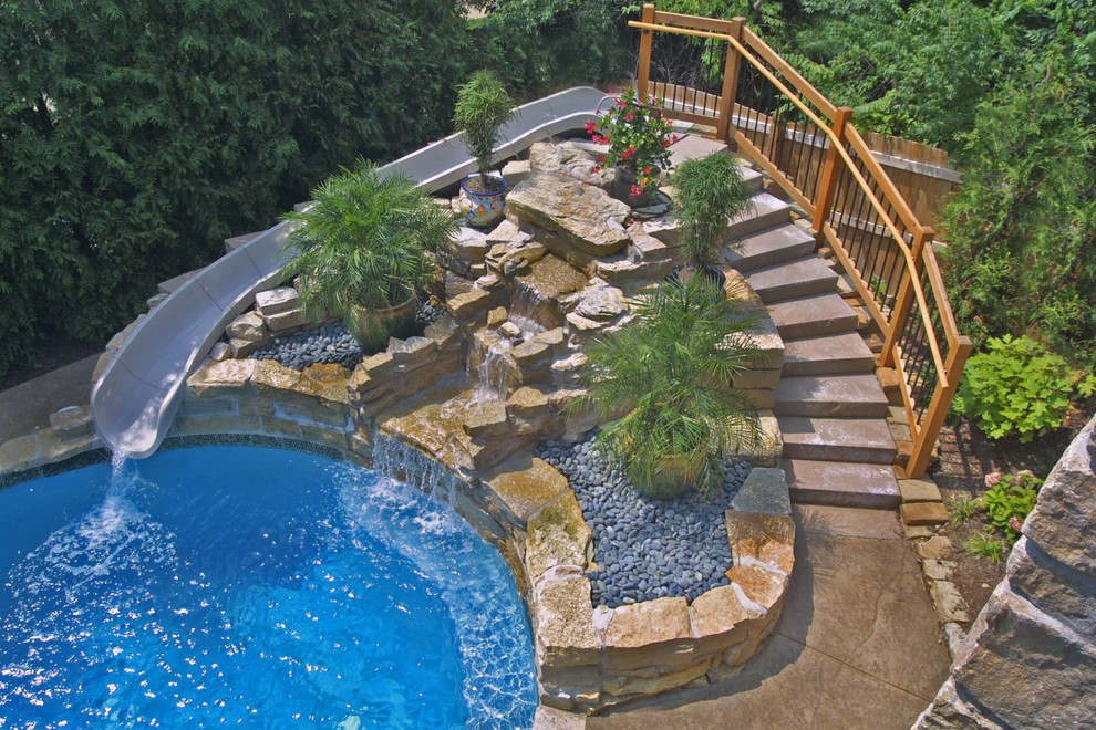 Example of a mid-sized trendy backyard stone and custom-shaped water slide design in St Louis