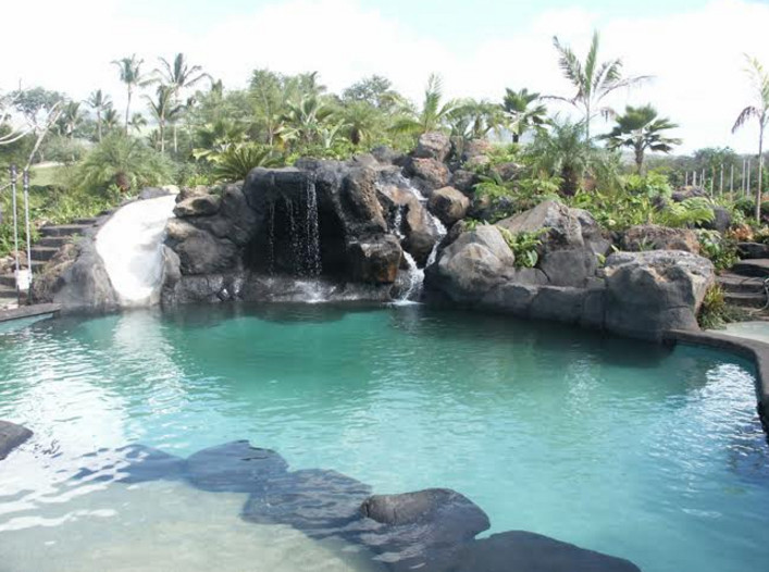 Inspiration for a large tropical backyard stone and custom-shaped natural water slide remodel in Hawaii