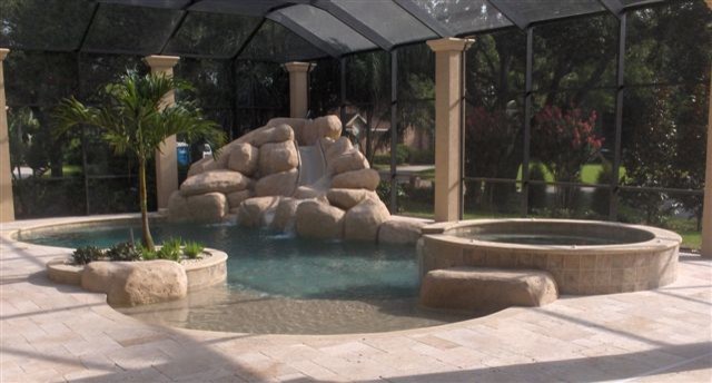 Inspiration for a backyard brick and custom-shaped water slide remodel in Tampa
