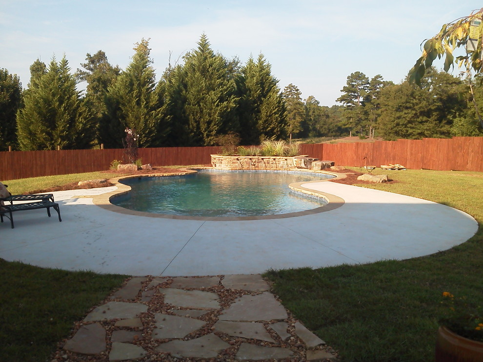 Example of a large transitional backyard custom-shaped and stone natural pool fountain design in Atlanta