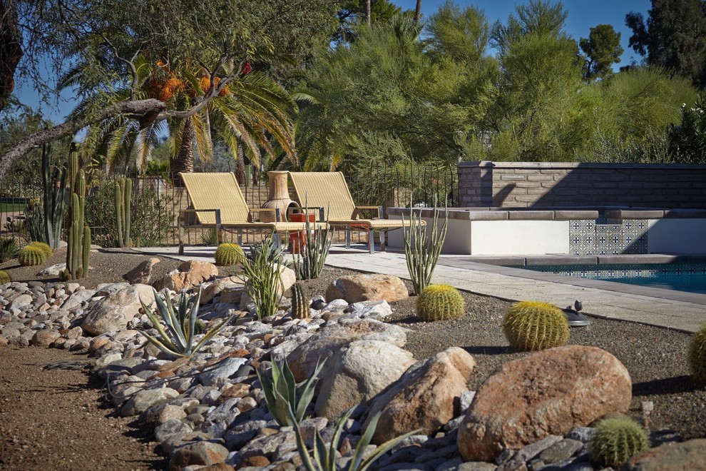 Ejemplo de piscinas y jacuzzis alargados de estilo americano grandes rectangulares en patio trasero con adoquines de hormigón