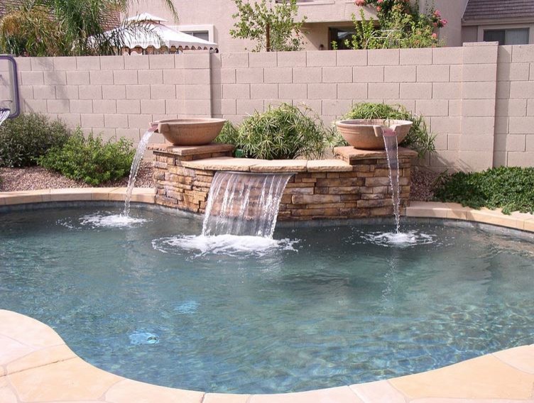 Example of a mid-sized trendy backyard stamped concrete and custom-shaped natural pool fountain design in Phoenix