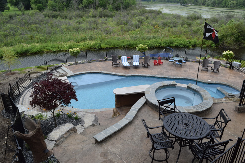 Foto de piscina con fuente natural extra grande a medida en patio trasero