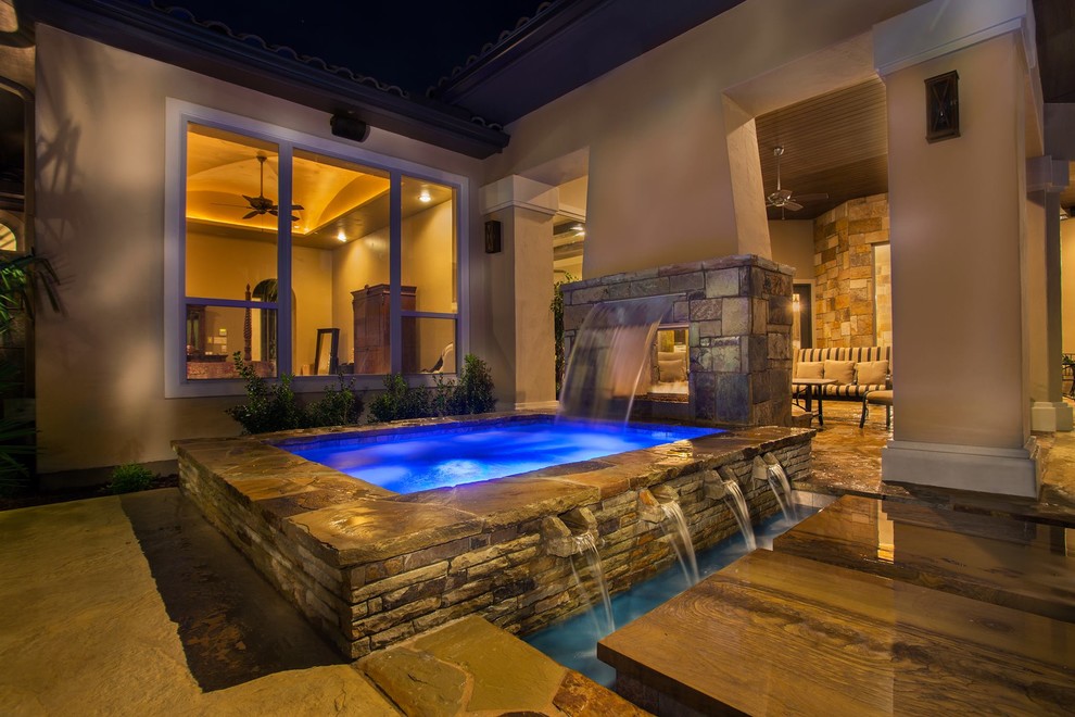 Medium sized classic back custom shaped natural hot tub in Dallas with natural stone paving.