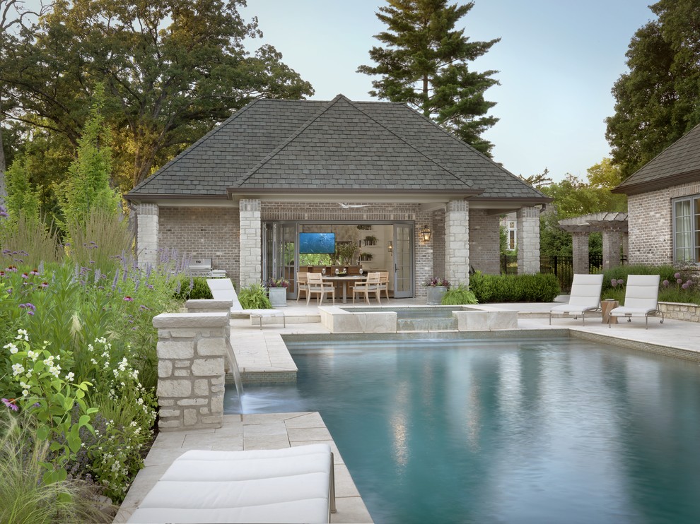 Design ideas for a large traditional back rectangular lengths swimming pool in St Louis with a pool house and concrete paving.