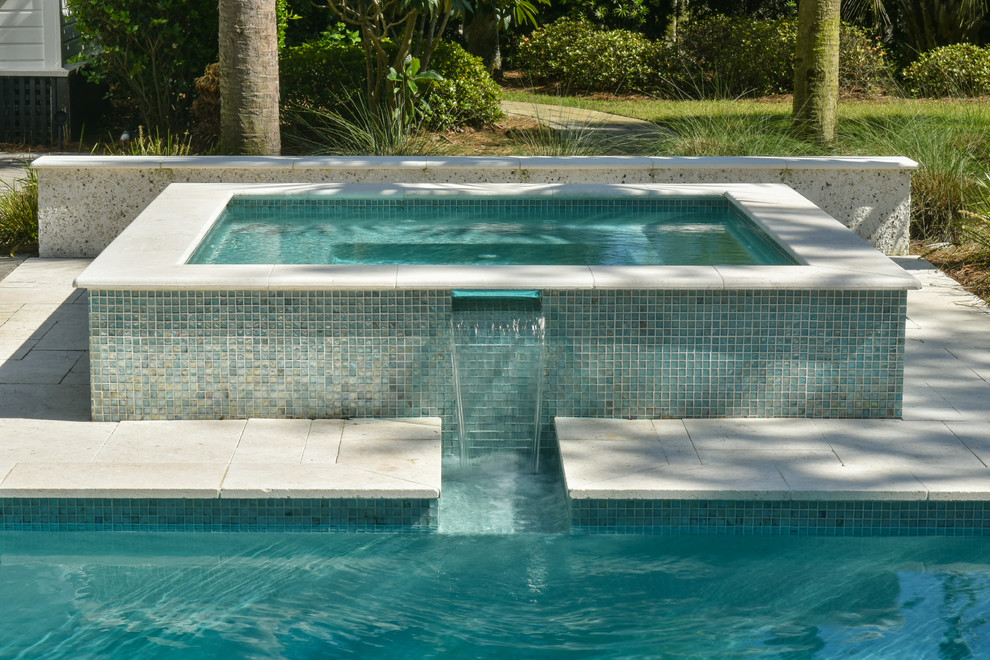 Mid-sized backyard stone and rectangular lap hot tub photo in Charleston