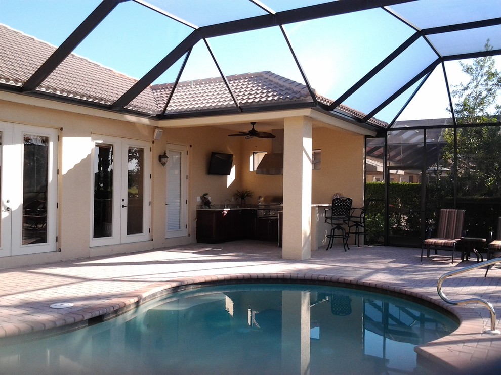 Medium sized world-inspired back custom shaped swimming pool in Miami with concrete paving.