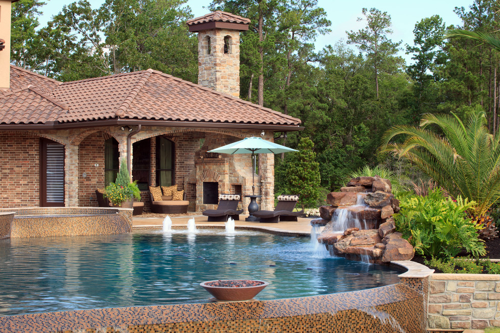 Huge tuscan backyard custom-shaped infinity pool fountain photo in Houston