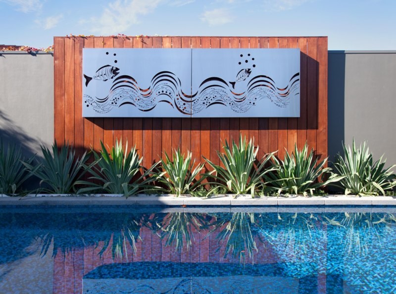 Outdoor living By the pool with Entanglements laser cut metal art