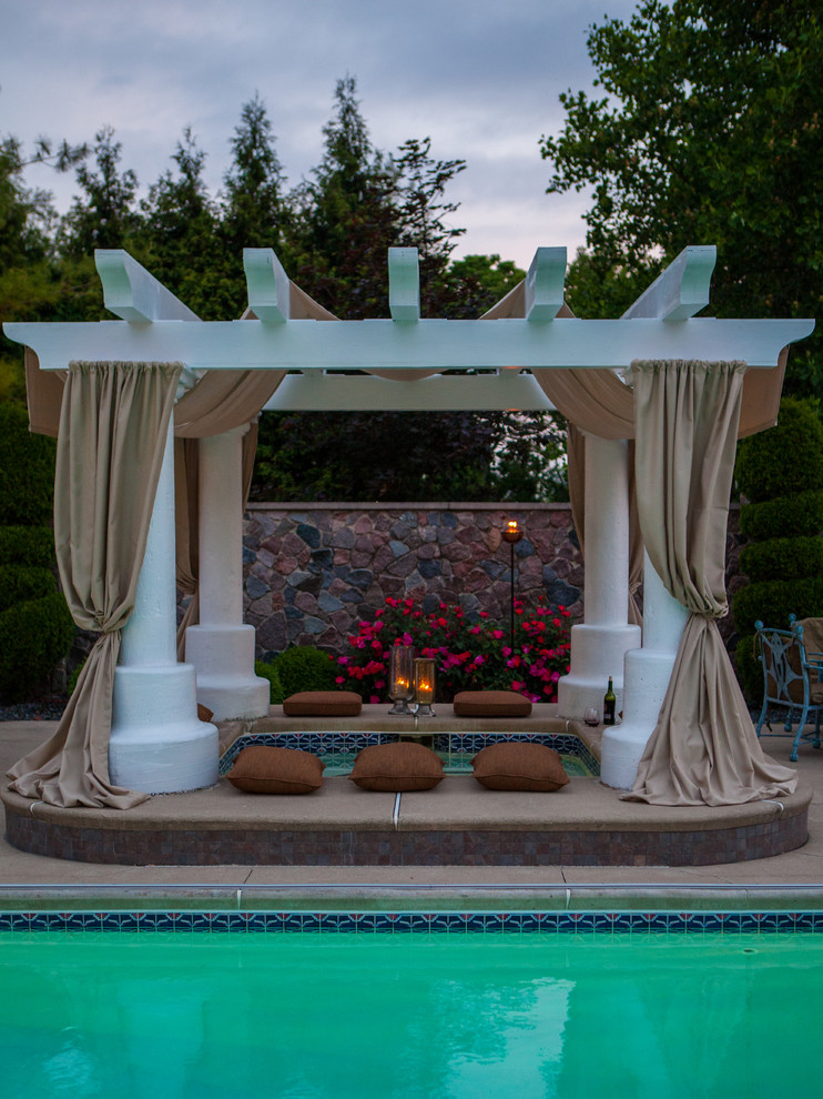 Inspiration for a large timeless backyard rectangular and concrete lap hot tub remodel in Other