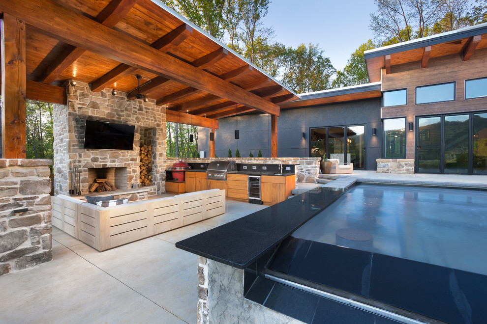 Idee per una piscina contemporanea rettangolare dietro casa con pavimentazioni in pietra naturale
