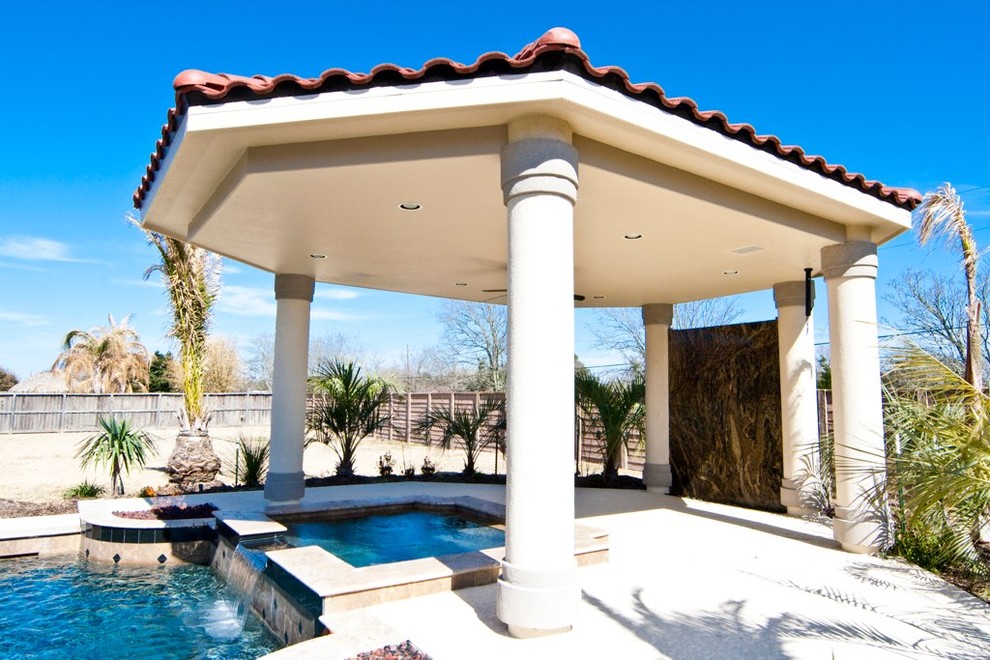 Inspiration for a mid-sized mediterranean backyard concrete paver and rectangular hot tub remodel in Houston