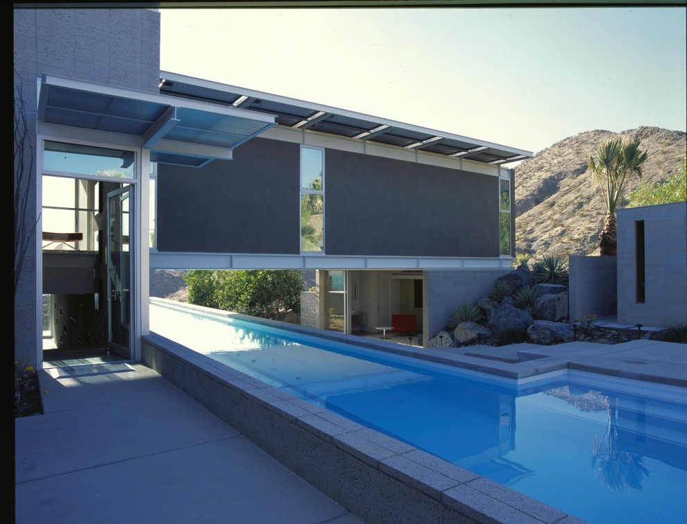 Pool - huge contemporary side yard concrete and l-shaped lap pool idea in Los Angeles