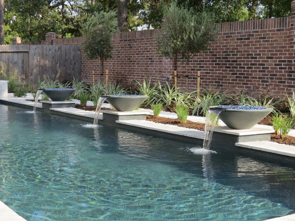 Moderner Pool in L-Form mit Betonplatten in Houston