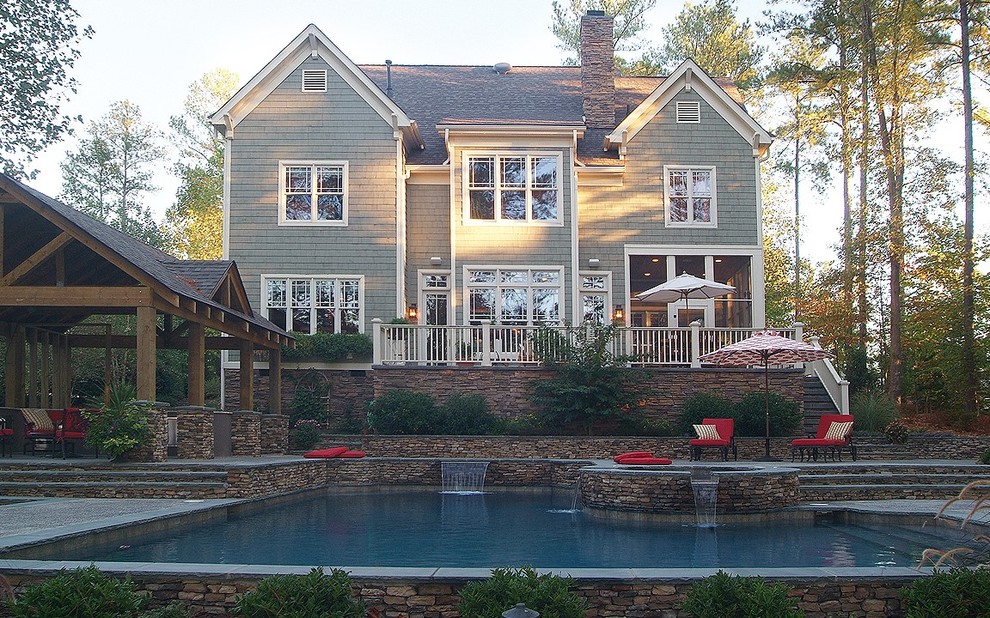 Idee per una grande piscina monocorsia contemporanea rettangolare dietro casa con una vasca idromassaggio e pavimentazioni in pietra naturale