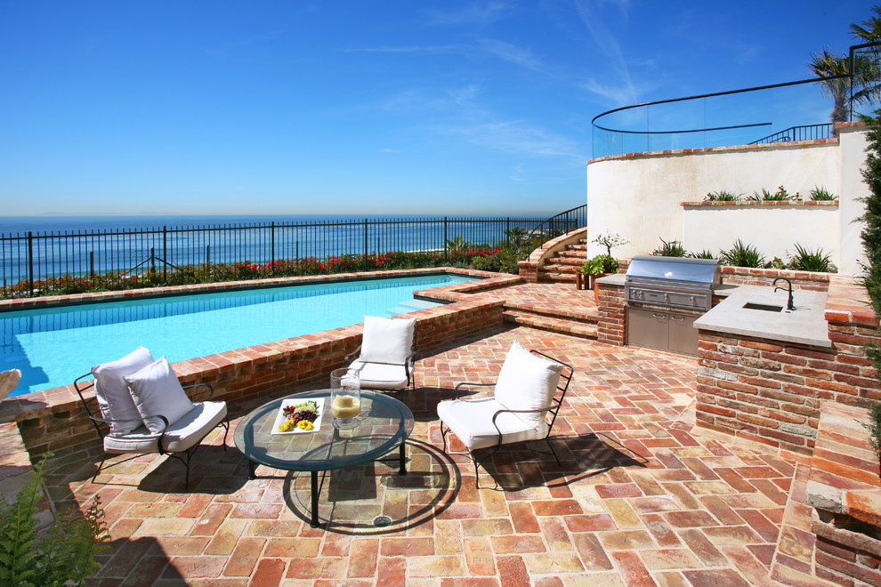 Inspiration for a timeless brick pool remodel in Orange County