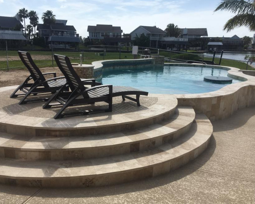 Photo of a medium sized coastal back custom shaped natural swimming pool in Orange County.