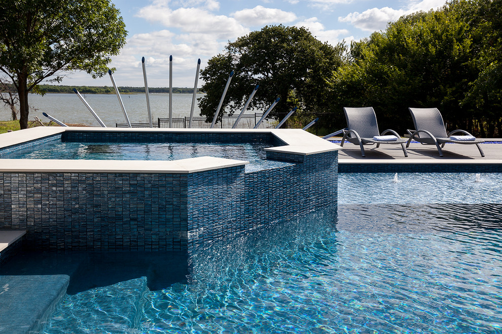 Inspiration for a large contemporary back rectangular lengths hot tub in Dallas with concrete paving.